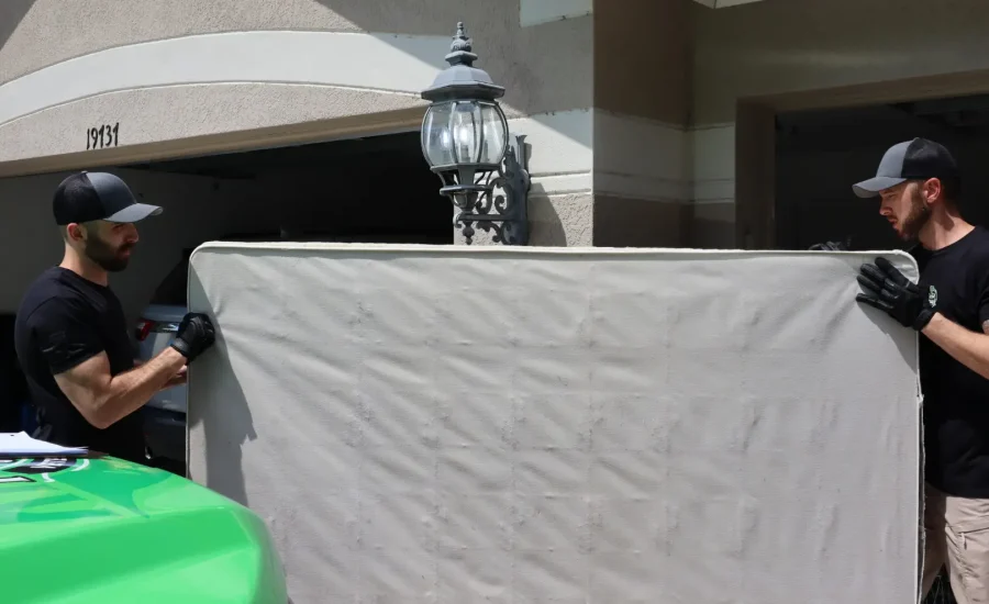 men removing a mattress